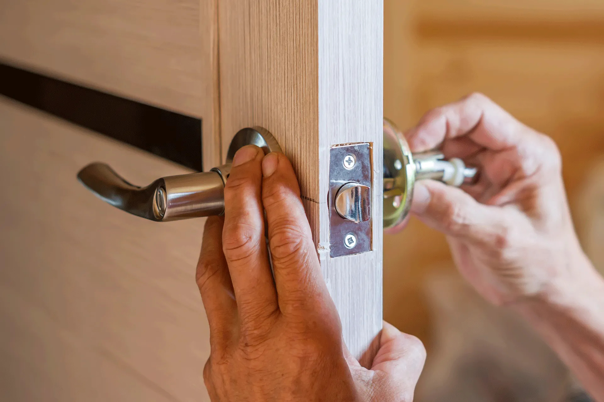Person repairing a door handle after picking a lock.