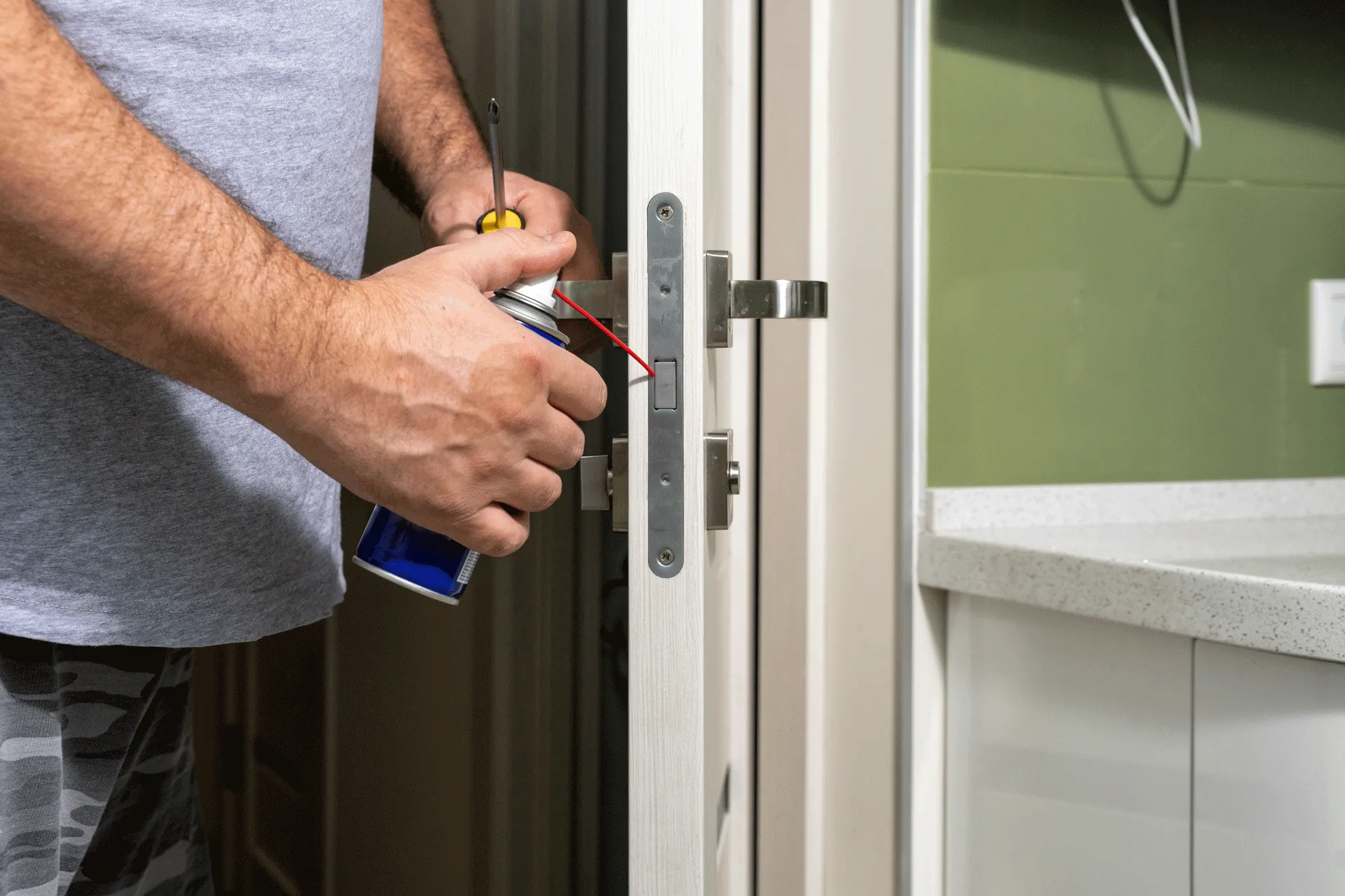 Person oiling a door after picking a lock.